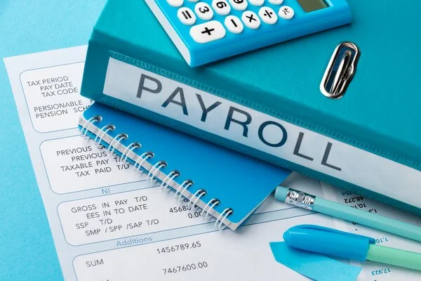 Team member processing payroll data for client employees